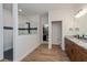 Elegant bathroom with glass-enclosed shower, wood floors, and dual vanities; bright and spacious at 1845 Springhead Dr, Deltona, FL 32725