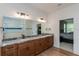 Luxury bathroom featuring double sinks, granite countertops, and modern lighting fixtures at 1845 Springhead Dr, Deltona, FL 32725