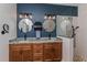 Stylish bathroom with double sinks, a walk-in shower, and elegant lighting fixtures; modern elegance at 1845 Springhead Dr, Deltona, FL 32725