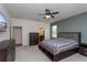 Comfortable bedroom with striped bedding, side tables, and carpeted floor; a calm retreat at 1845 Springhead Dr, Deltona, FL 32725