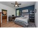 Comfortable bedroom with natural light, a desk, and a view of the bathroom; bright and inviting at 1845 Springhead Dr, Deltona, FL 32725