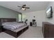 Spacious bedroom with ceiling fan, gray carpet, and furniture; a comfortable and functional space at 1845 Springhead Dr, Deltona, FL 32725