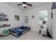 Bright bedroom features unique decor, neutral walls, ceiling fan, and natural light at 1845 Springhead Dr, Deltona, FL 32725