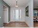 Bright entryway featuring wood-look tile flooring, decorative accents, and a modern front door at 1845 Springhead Dr, Deltona, FL 32725