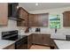 Well-appointed kitchen with a modern range hood, updated appliances, and stylish finishes at 1845 Springhead Dr, Deltona, FL 32725