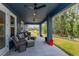 Covered porch features outdoor seating and ceiling fans at 1845 Springhead Dr, Deltona, FL 32725