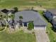 An aerial view shows the attractive home with a screened in patio and golf course behind the property at 204 Birkdale St, Davenport, FL 33897