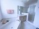 Bright bathroom featuring a soaking tub, tile floors, and a glass-enclosed shower at 204 Birkdale St, Davenport, FL 33897