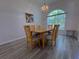 Formal dining room featuring a contemporary chandelier, natural light, and seating for six, ideal for Gathering gatherings at 204 Birkdale St, Davenport, FL 33897