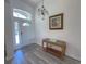 Bright foyer features wood floors, a decorative light fixture, and a classic console table at 204 Birkdale St, Davenport, FL 33897