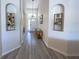 Well lit foyer showcases wood floors and art niches that add character to the entrance space at 204 Birkdale St, Davenport, FL 33897