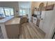 Bright kitchen featuring light wood cabinets, white appliances, and an open layout with views of the pool at 204 Birkdale St, Davenport, FL 33897