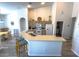 Spacious kitchen with an island, white appliances, light wood cabinets, and a view to the dinette at 204 Birkdale St, Davenport, FL 33897