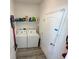 Functional laundry room with a washer, dryer, shelving and white walls and neutral flooring at 204 Birkdale St, Davenport, FL 33897