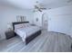 Cozy main bedroom with a ceiling fan, an ensuite bathroom, and a spacious closet, designed for relaxation at 204 Birkdale St, Davenport, FL 33897