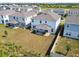 Aerial view of backyard and patio space of a two-story home in a residential neighborhood at 2056 Airedale Way, Lake Alfred, FL 33850