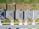 Aerial shot of rooftops and driveways in a residential neighborhood on a sunny day at 2056 Airedale Way, Lake Alfred, FL 33850
