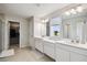 Bathroom featuring dual vanities, ample counter space, and natural light at 2056 Airedale Way, Lake Alfred, FL 33850