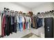 Walk-in closet with wire shelving stocked with clothing and shoes, plus a secure safe at 2056 Airedale Way, Lake Alfred, FL 33850