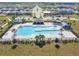 Aerial shot of a large community pool with ample lounging space and clear blue water at 2056 Airedale Way, Lake Alfred, FL 33850