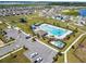 Aerial view of a community pool with playground, parking and lounge chairs at 2056 Airedale Way, Lake Alfred, FL 33850