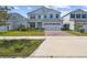Charming two-story home with a well-manicured lawn and appealing curb appeal, showcasing a modern design at 2056 Airedale Way, Lake Alfred, FL 33850