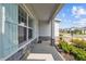 Charming covered front porch with stone accents, a welcoming entrance, and meticulously maintained landscaping at 2056 Airedale Way, Lake Alfred, FL 33850