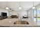 Granite kitchen island with sink overlooking the living and dining area, offering a seamless flow at 2056 Airedale Way, Lake Alfred, FL 33850
