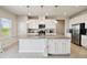 Modern kitchen with white cabinets, granite countertops, stainless steel appliances, and a large center island at 2056 Airedale Way, Lake Alfred, FL 33850