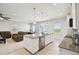 Open-concept kitchen with an island overlooking the living and dining areas, creating a spacious feel at 2056 Airedale Way, Lake Alfred, FL 33850