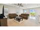 Open living room with comfortable seating, a ceiling fan, and sliding glass doors to the backyard at 2056 Airedale Way, Lake Alfred, FL 33850
