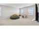 Bright play room with comfortable seating, a study area, and natural light from two windows at 2056 Airedale Way, Lake Alfred, FL 33850