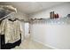 Organized walk-in closet with shelving and hanging rods to maximize storage efficiency at 2056 Airedale Way, Lake Alfred, FL 33850