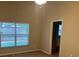 Bright bedroom featuring a vaulted ceiling, large window, and neutral color scheme at 2131 Kaylas Ct, Orlando, FL 32817