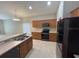 Bright kitchen with stainless steel appliances, breakfast bar and dark cabinets at 2131 Kaylas Ct, Orlando, FL 32817
