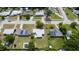 Wide aerial view of the property in a neighborhood featuring well-maintained lawns and mature trees at 226 Palmyra Dr, Orlando, FL 32807