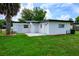 Well-maintained backyard and a freshly painted exterior featuring multiple access doors at 226 Palmyra Dr, Orlando, FL 32807