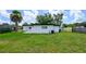 Backyard view showcasing lush lawn with recent landscaping and a newly painted exterior at 226 Palmyra Dr, Orlando, FL 32807