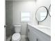 Bathroom features a double sink vanity, modern fixtures, and gray tiled shower at 226 Palmyra Dr, Orlando, FL 32807