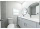 Bathroom features a double sink vanity, modern fixtures, and gray tiled shower at 226 Palmyra Dr, Orlando, FL 32807