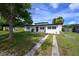Inviting exterior featuring a newly painted home, vibrant landscaping, and a lush green lawn at 226 Palmyra Dr, Orlando, FL 32807