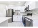 Well-lit kitchen boasts stainless steel appliances, white cabinets and modern tile backsplash at 226 Palmyra Dr, Orlando, FL 32807