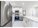 This spacious kitchen includes stainless steel appliances, an island, white cabinets and tile flooring at 226 Palmyra Dr, Orlando, FL 32807
