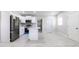 This kitchen includes stainless steel appliances, an island, white cabinets and tile flooring at 226 Palmyra Dr, Orlando, FL 32807