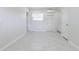 Spacious living room offers white walls, tile floors, a mini split system, and exterior access at 226 Palmyra Dr, Orlando, FL 32807