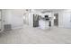 A view of the open concept room with white cabinets, stainless steel appliances and tile floors at 226 Palmyra Dr, Orlando, FL 32807