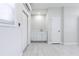 Utility room offers mini split, a sink, and a white cabinet for storing supplies at 226 Palmyra Dr, Orlando, FL 32807