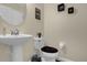 Cozy half bathroom featuring a pedestal sink, toilet, and minimalist décor at 2261 Brookridge Trl, Sanford, FL 32773