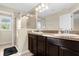 Bright bathroom featuring a double vanity and glass-enclosed shower at 2261 Brookridge Trl, Sanford, FL 32773