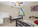 Shared bedroom with a ceiling fan, two twin beds, a desk and ample sunlight at 2261 Brookridge Trl, Sanford, FL 32773